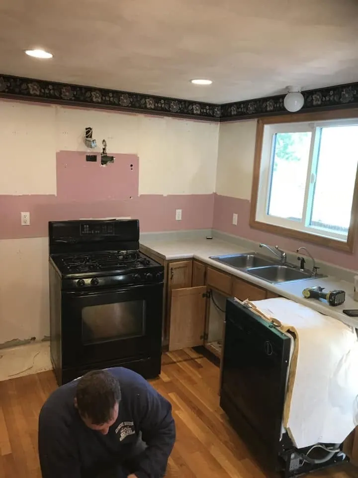 Dated kitchen with pink tile wall before the remodel