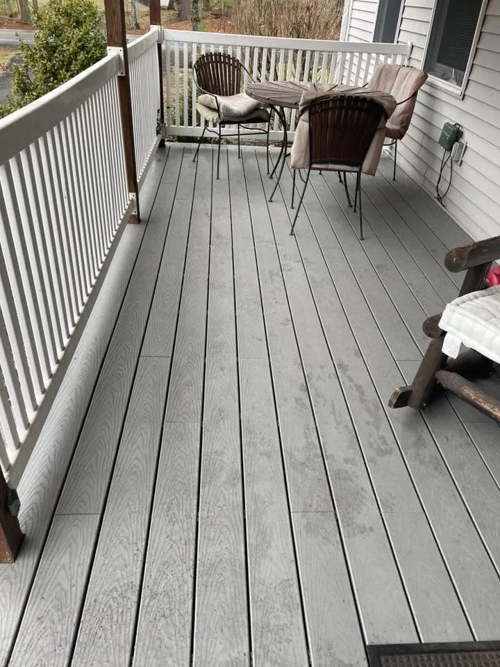 Porch with new gray deck boards and white railings